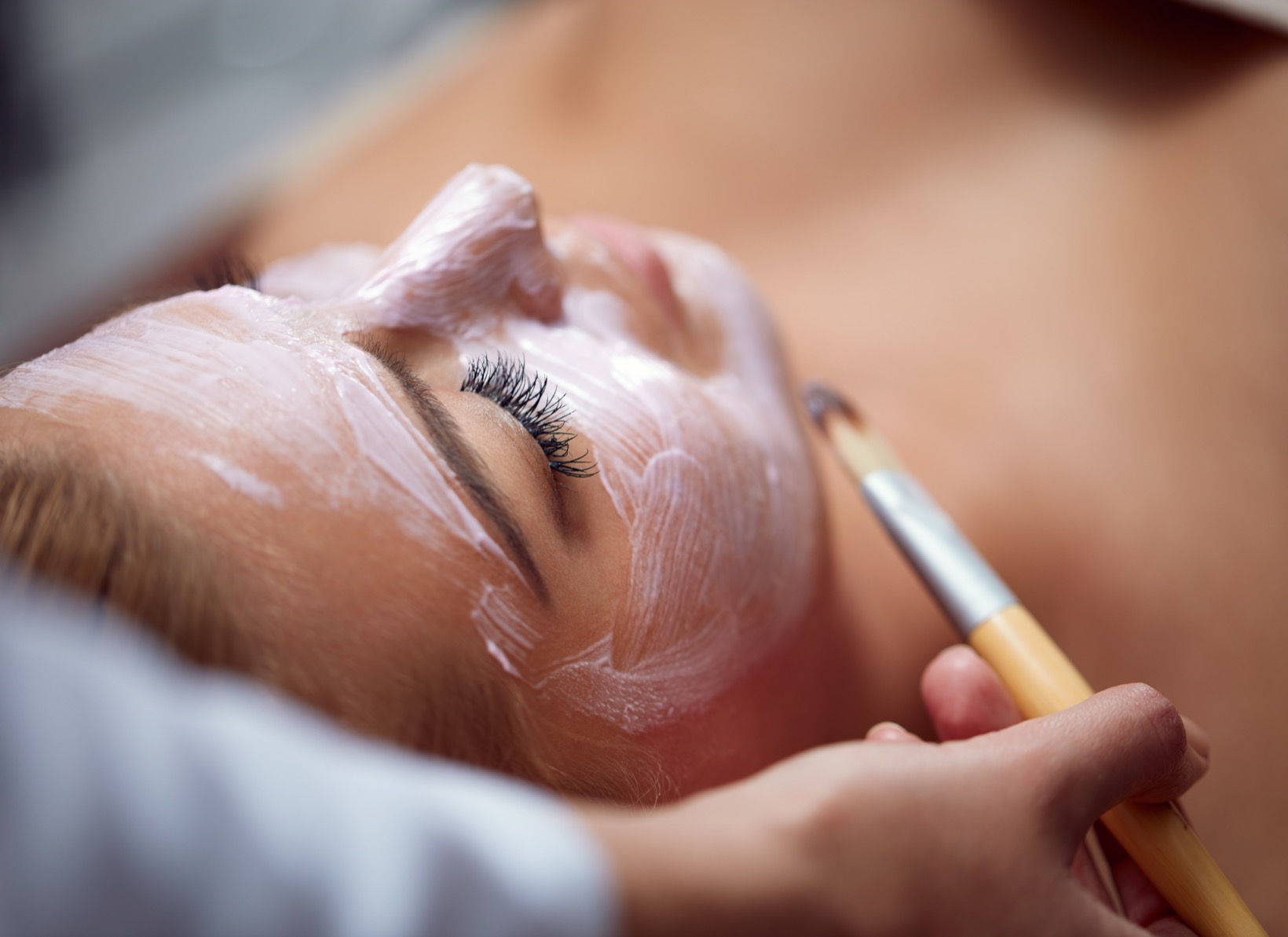 Beautiful young woman having a facial cosmetic treatment.
